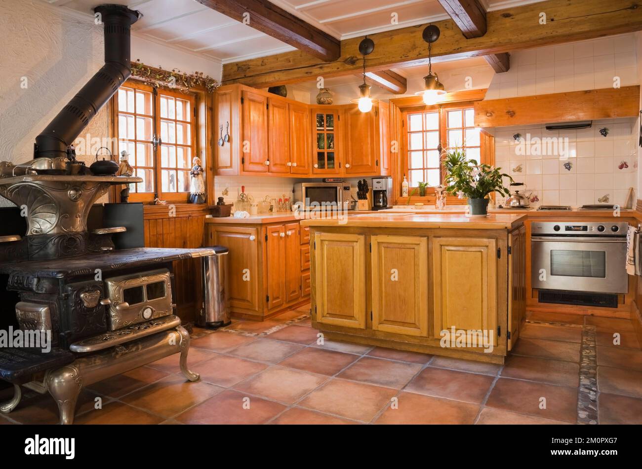 1919 Happy Thought wood burning stove and wooden cupboards in kitchen