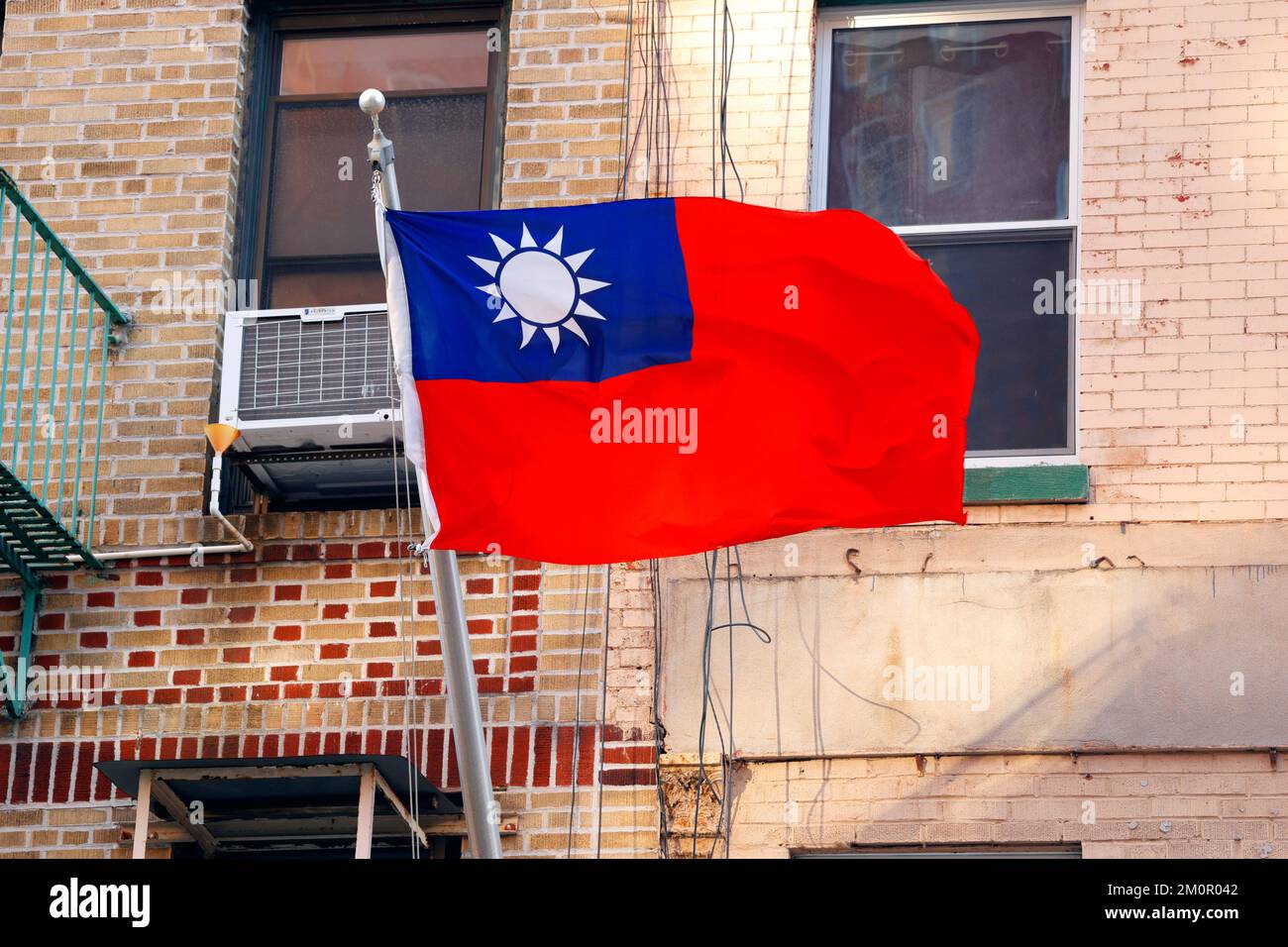 A flag of Taiwan flying in front of a building in Manhattan Chinatown, New York. Stock Photo