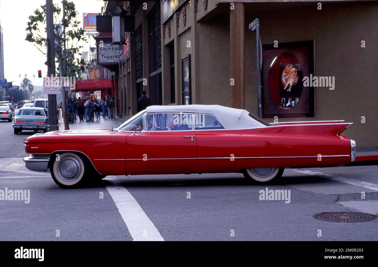 Classic 1960s Cadillac driving in Hollywood near the Chinese Theater, Los Angeles, CA Stock Photo