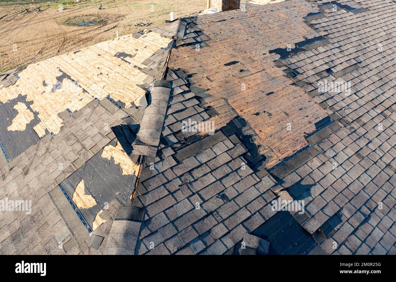 Tornado damage to roof and shingles. Stock Photo
