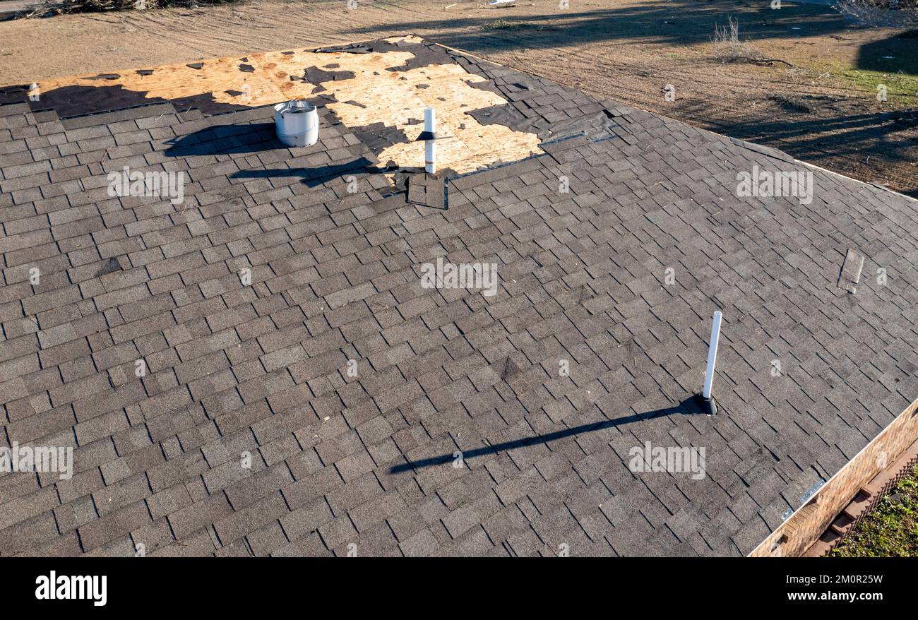 Tornado damage to roof and shingles. Stock Photo