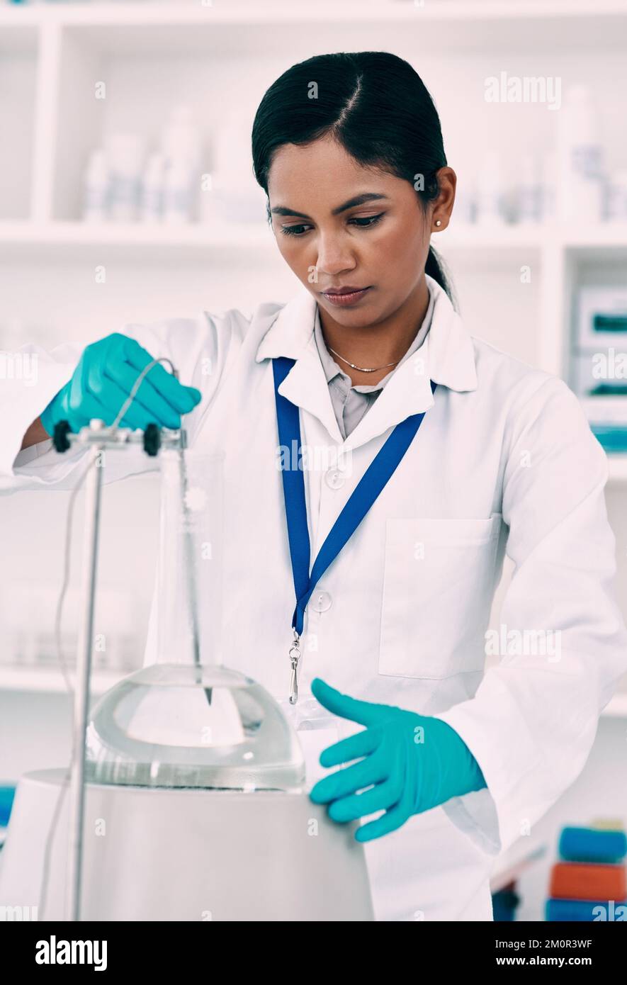 Conducting experiments to test her theories. an attractive young female