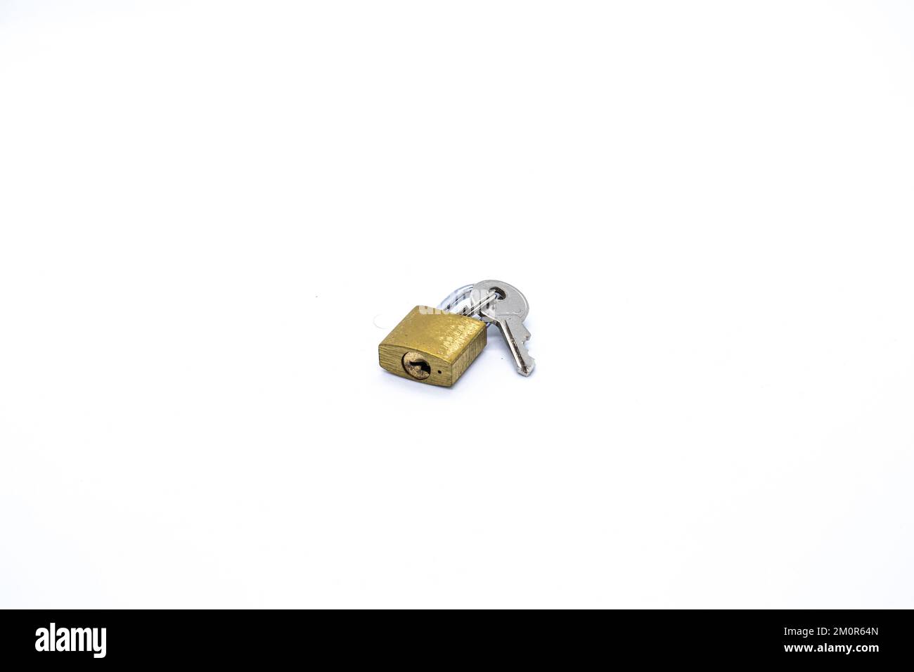 Padlock next to the key on white background Stock Photo Alamy