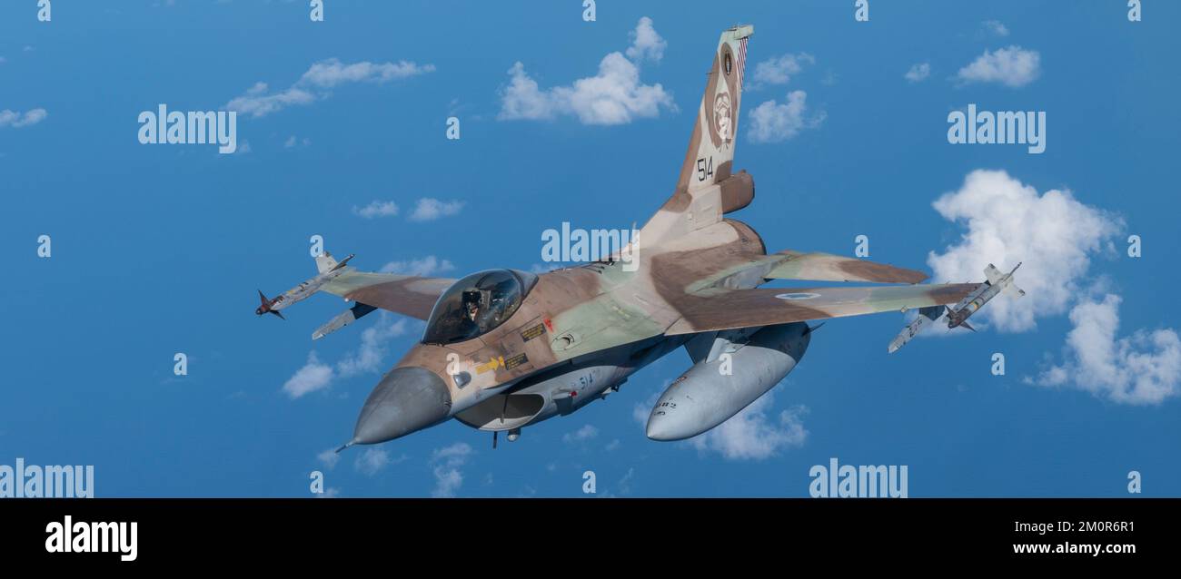 An Israeli Air Force F-16 Fighting Falcons flies in formation behind a U.S. Air Force KC-135 Stratotanker assigned to the 340th Expeditionary Air Refueling Squadron, as part of a bilateral exercise over an undisclosed location in the U.S. Central Command area of responsibility, Nov. 30, 2022. The exercise demonstrated fighter aircraft integration and escort as well as refueling operations as part of the first of several exercises to maintain the ironclad commitment and bilateral aerial capability between the U.S. and Israeli Air Forces. (U.S. Air Force photo by Staff Sgt. Kirby Turbak) Stock Photo