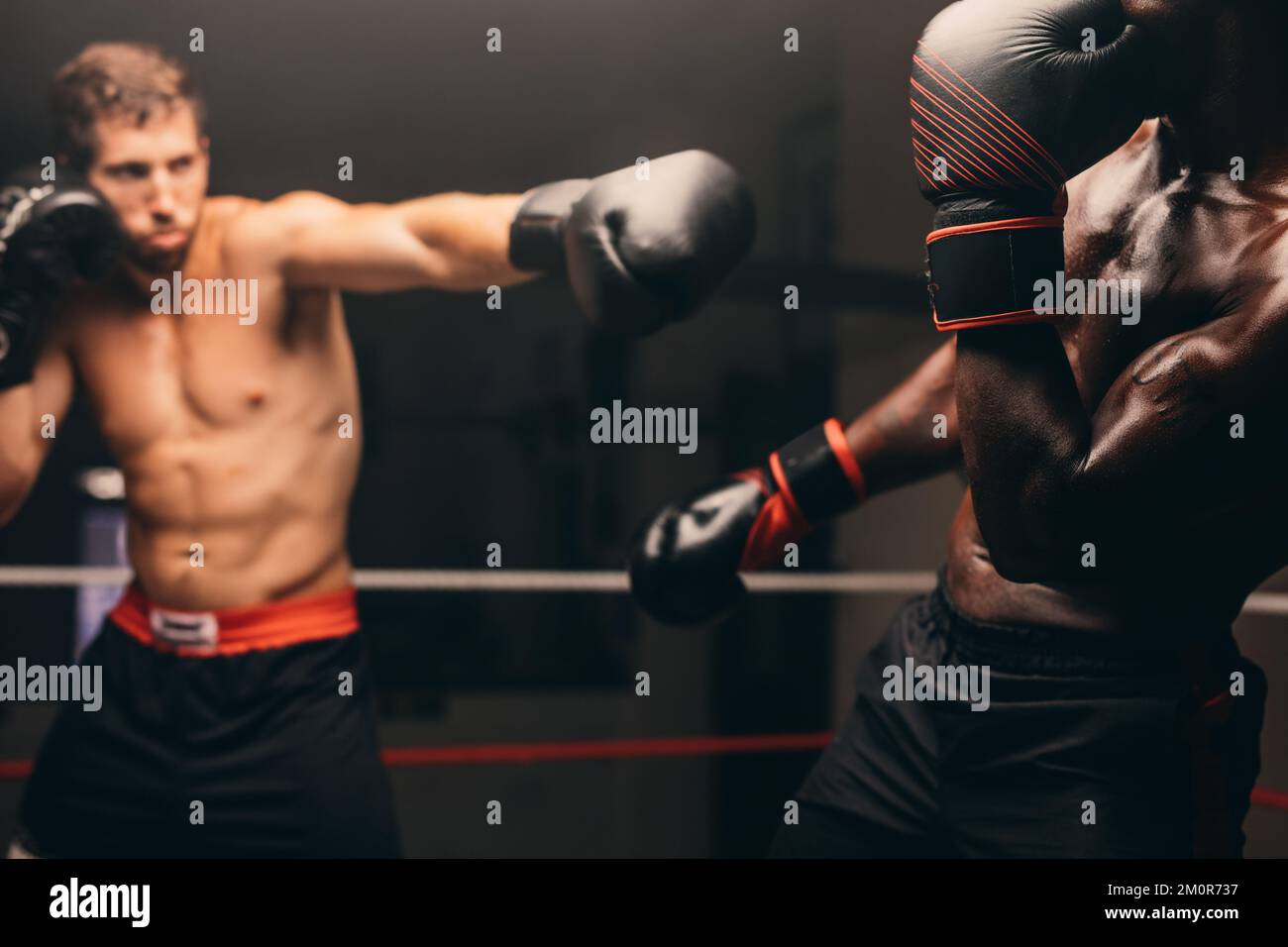 Boxer missing his opponent during a fight in a boxing ring. Two male