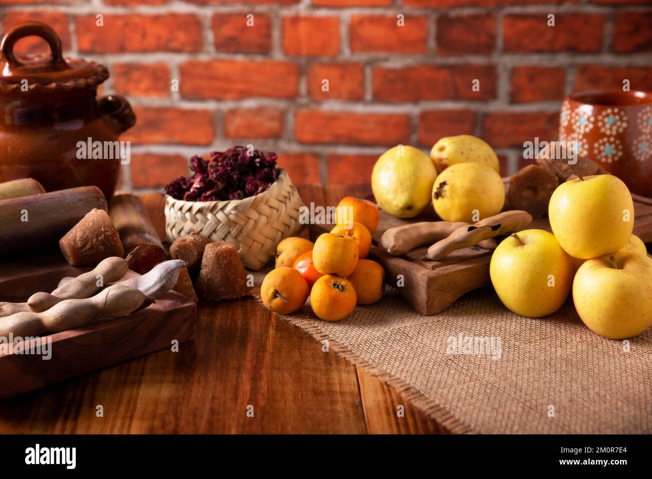 Basic ingredients to prepare Mexican fruit punch, a hot drink traditionally consumed during the December season at posadas and Christmas celebrations. Stock Photo