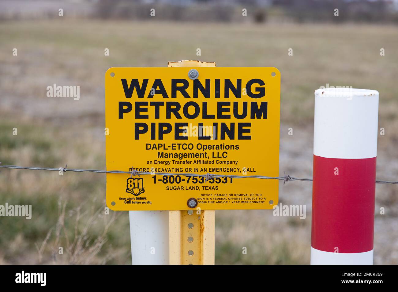 A warning sign and marker for the Dakota Access Pipeline in Lee County; Iowa Stock Photo