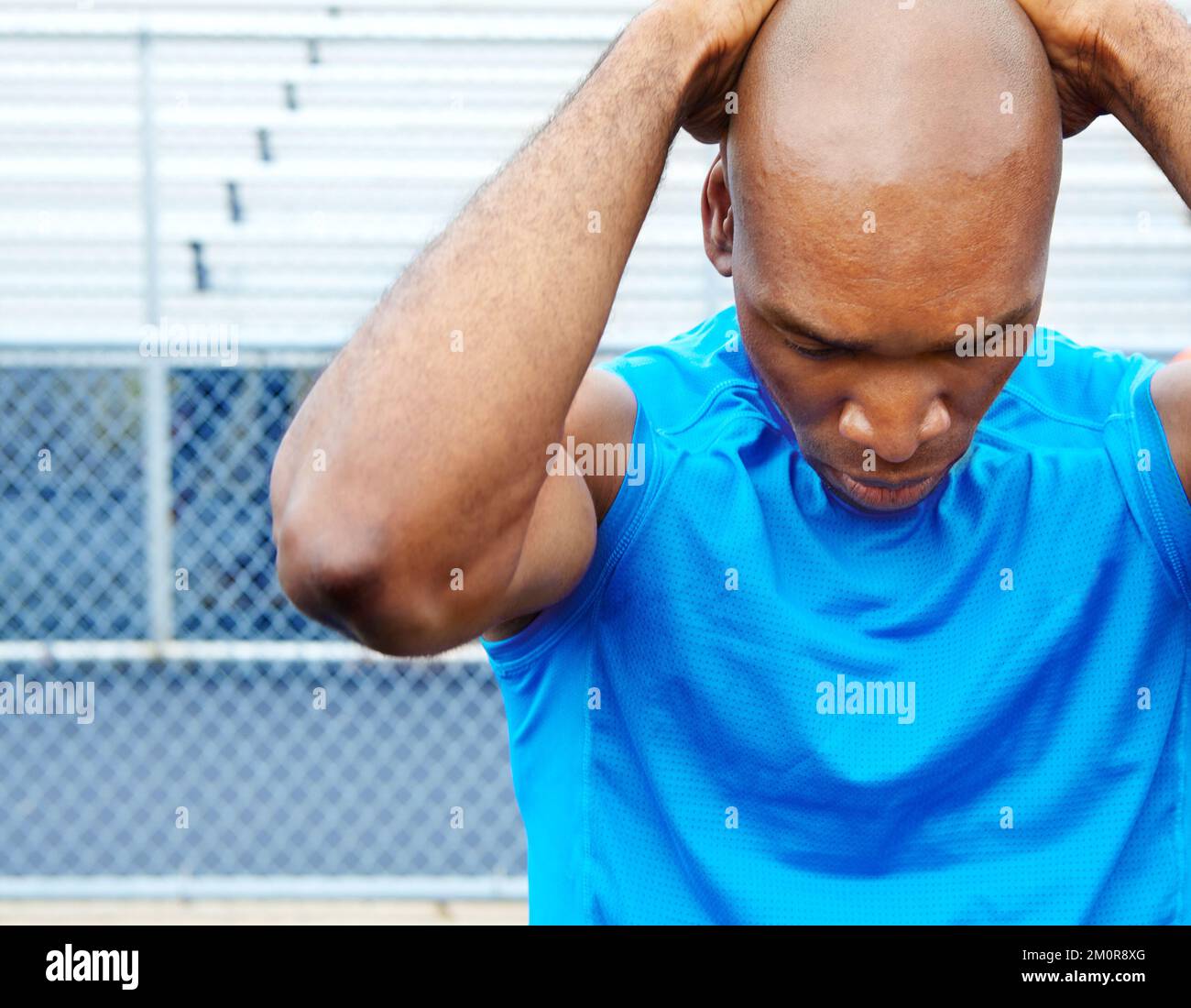 Feeling the pressure to win. Close up shot of a male athlete touching his head with focus. Stock Photo