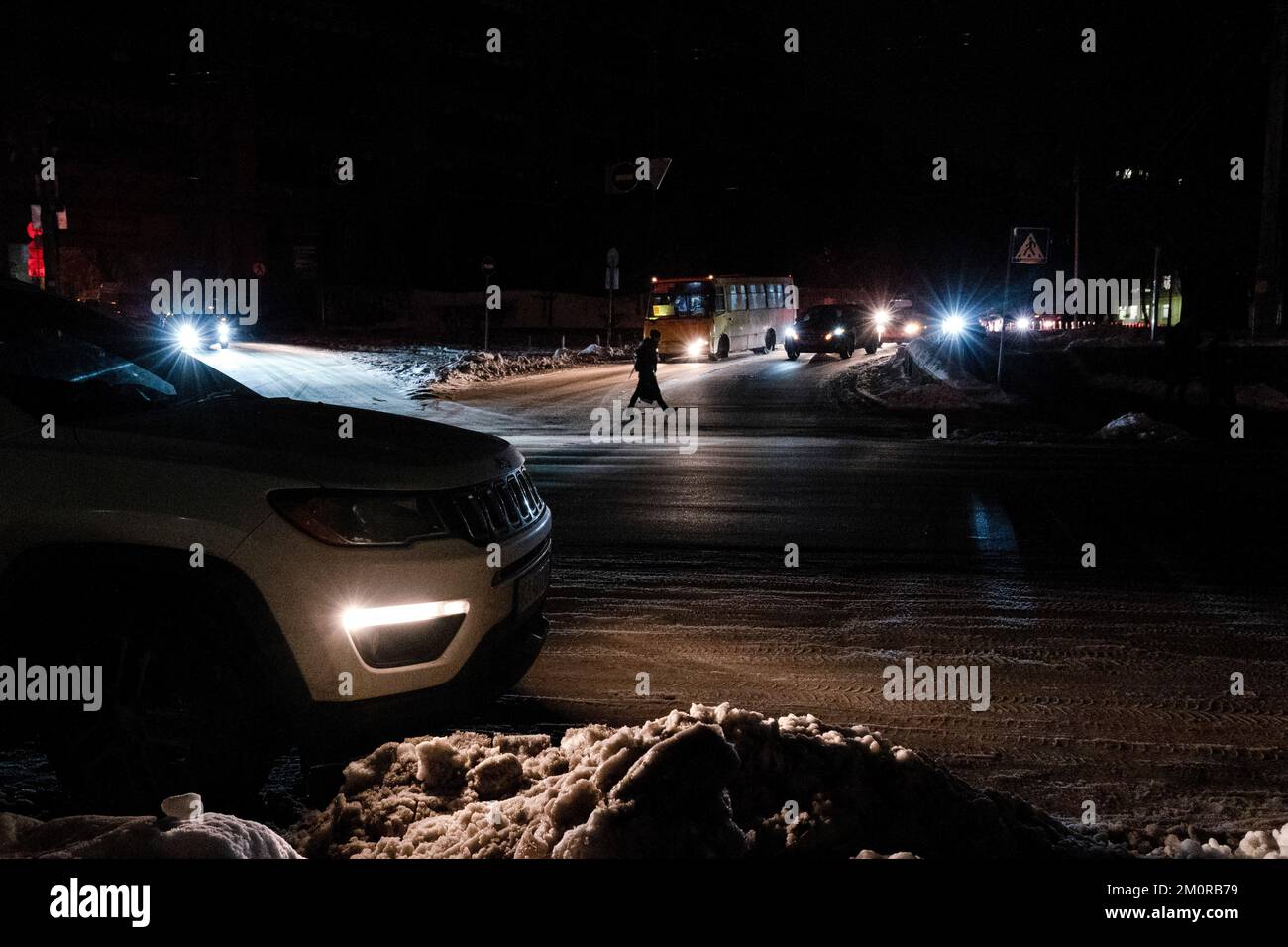 Kyiv, Ukraine. 01st Dec, 2022. A pedestrian was seen crossing the road without street light. Residents of Kyiv not only have to battle for the cold this winter, but they also are struggling for constant electricity outage due to Russian attack on the power grid. Credit: SOPA Images Limited/Alamy Live News Stock Photo