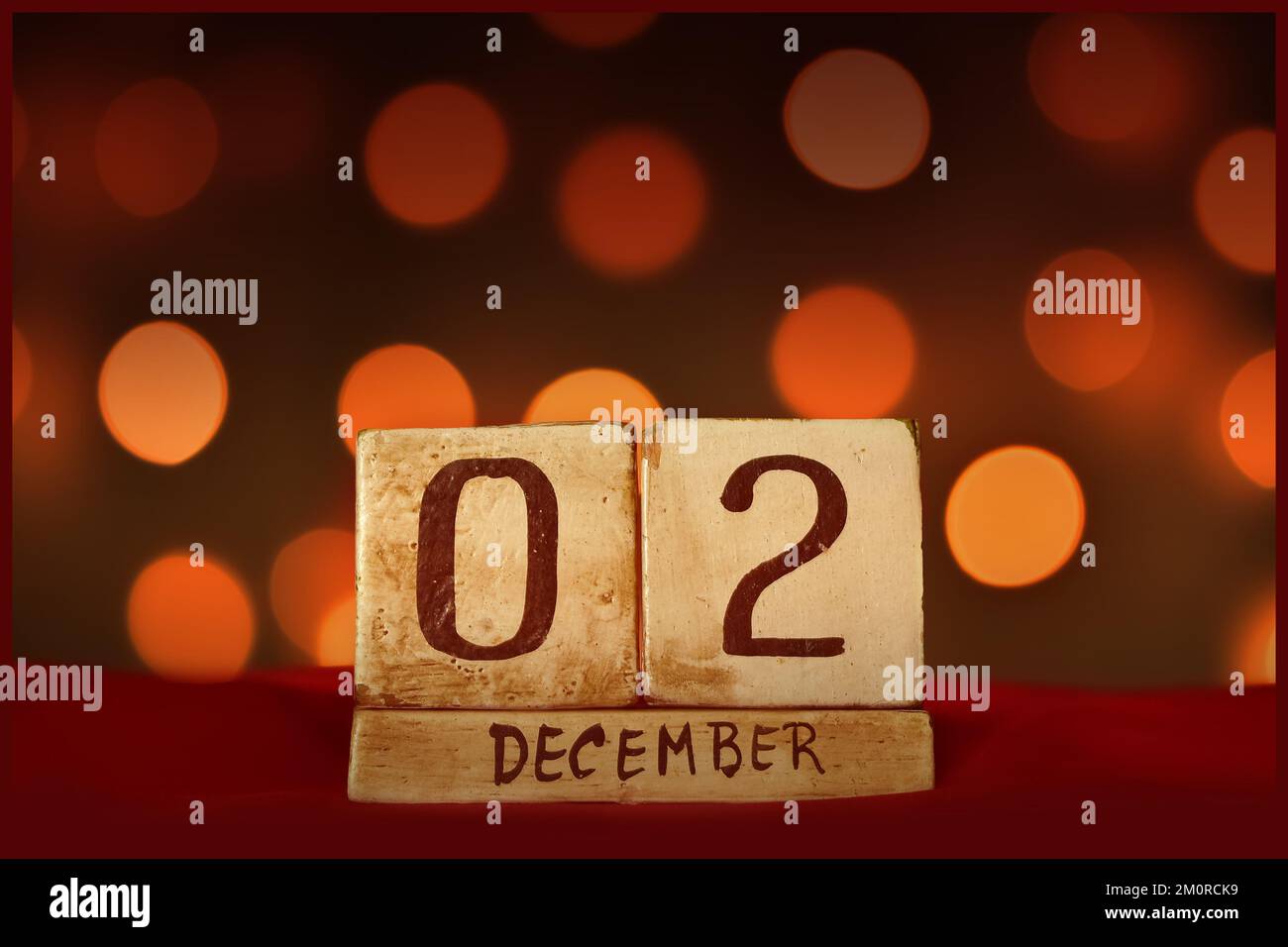 December 2 vintage wooden block calendar on red fabric, festive