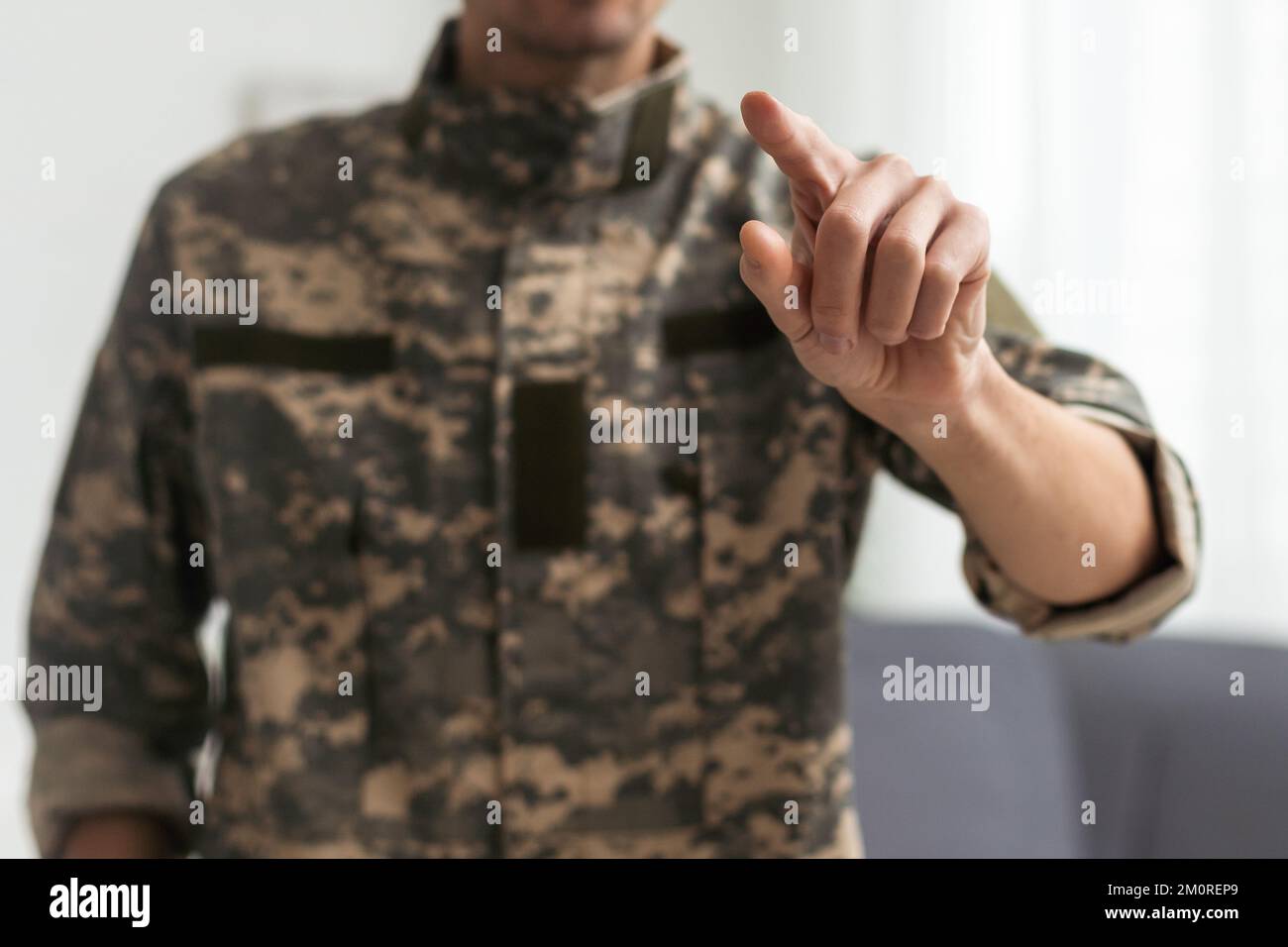 cropped view of soldier in uniform pointing with finger on white Stock Photo