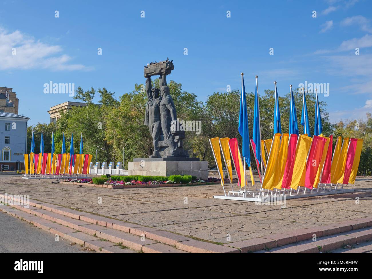 The landmark Miner's Glory monument, honoring all of the area workers who have worked in the coal, ore mines. The colorful flags are for the miner's d Stock Photo