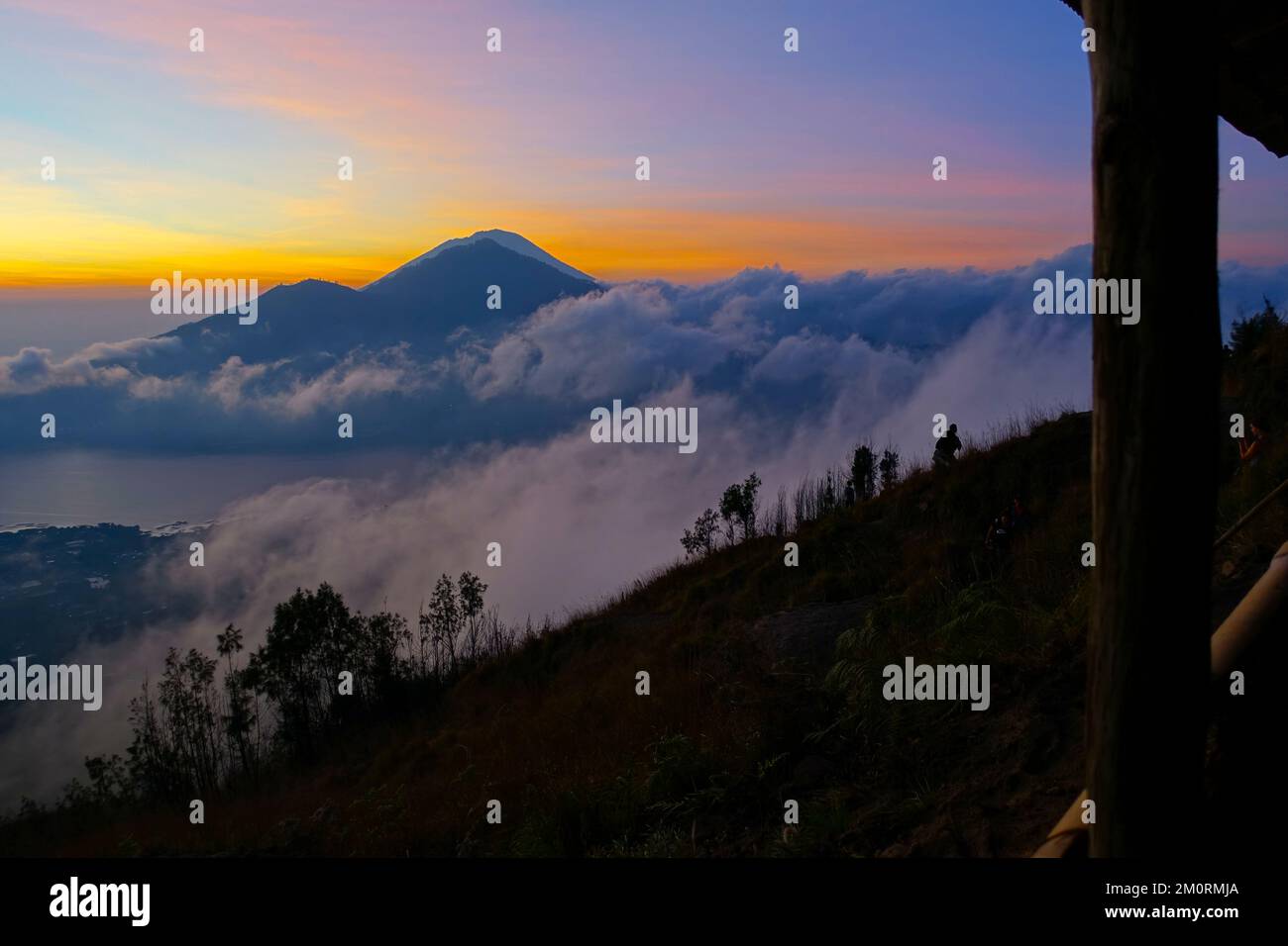 A beautiful sunrise over the mountain covered with clouds Stock Photo ...