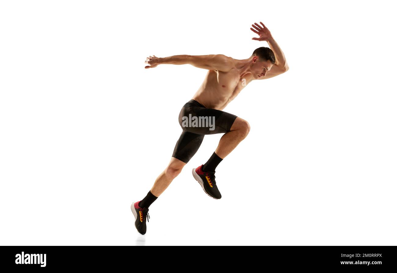 Sportive man, muscular athlete, runner wearing bicycle shorts in motion