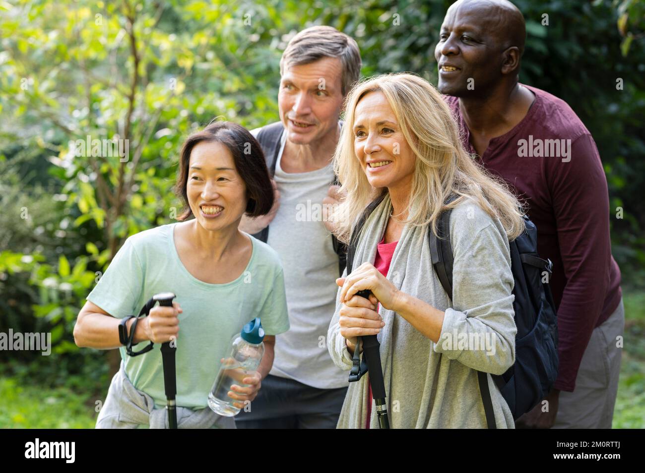 Group of diverse senior friends taking a break in their hike to pose for a photo Stock Photo