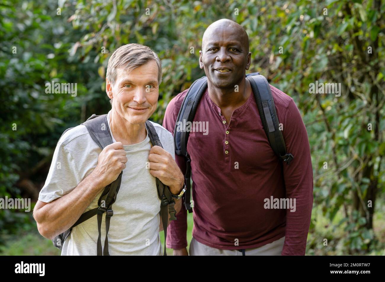 Two male friends hiking in the woods stop to take a picture Stock Photo ...