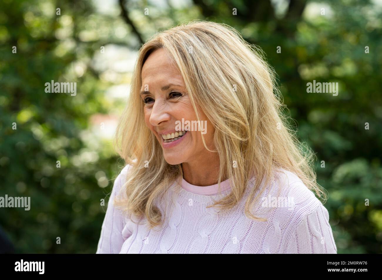 Portrait of middle aged woman smiling while enjoying time outdoors Stock Photo