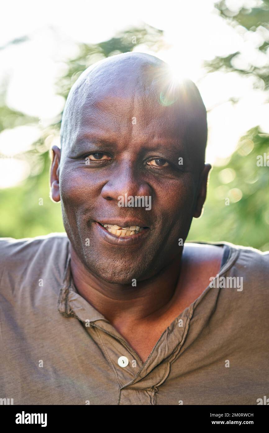Cheerful senior African American man looking at the camera while standing outdoors Stock Photo