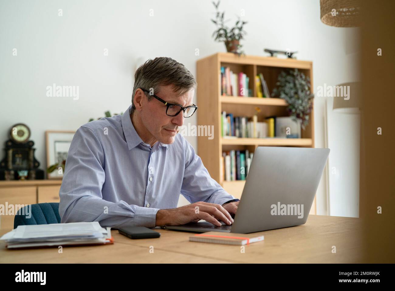 Senior businessman using laptop while working at home Stock Photo