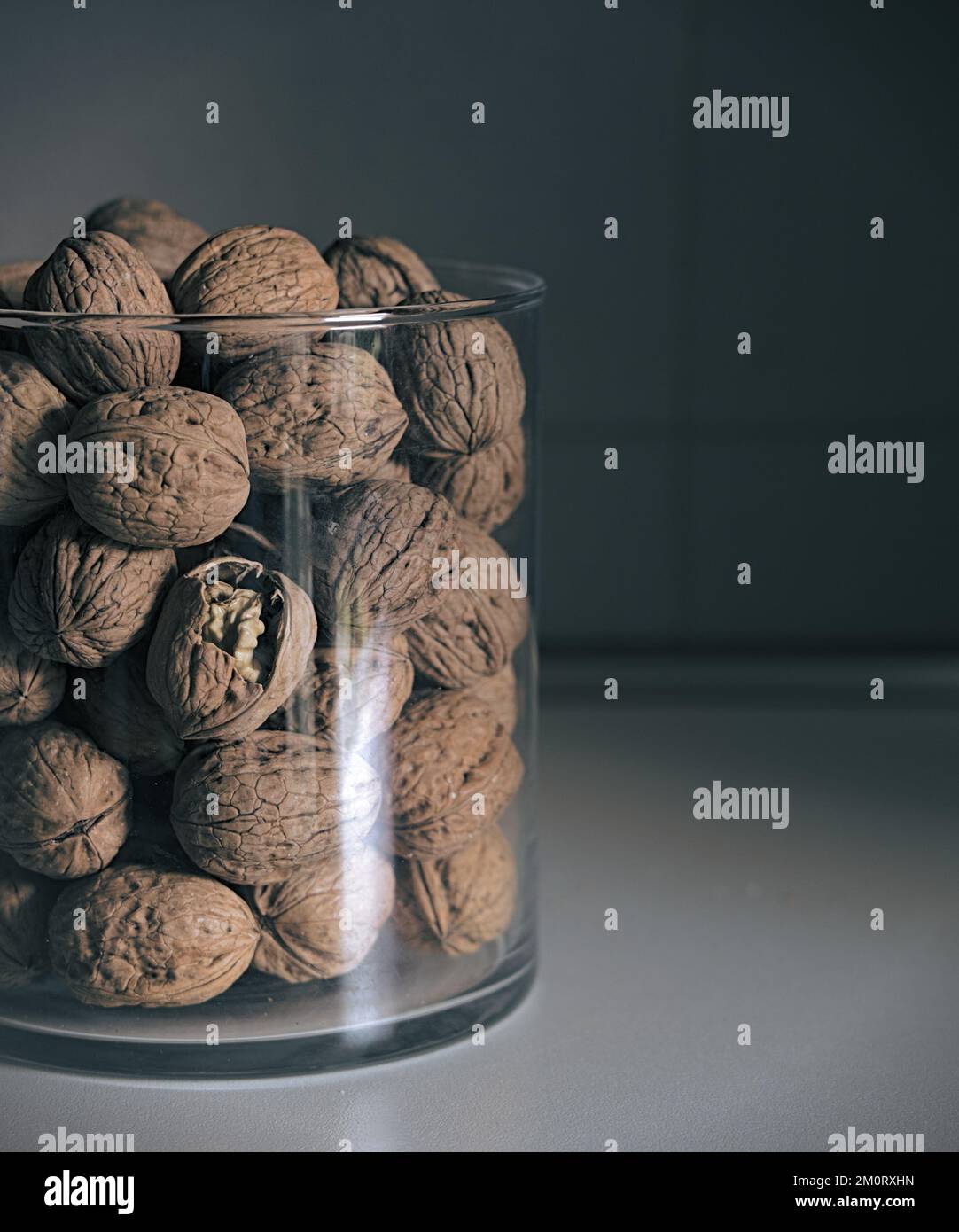 a glass container filled with nuts Stock Photo