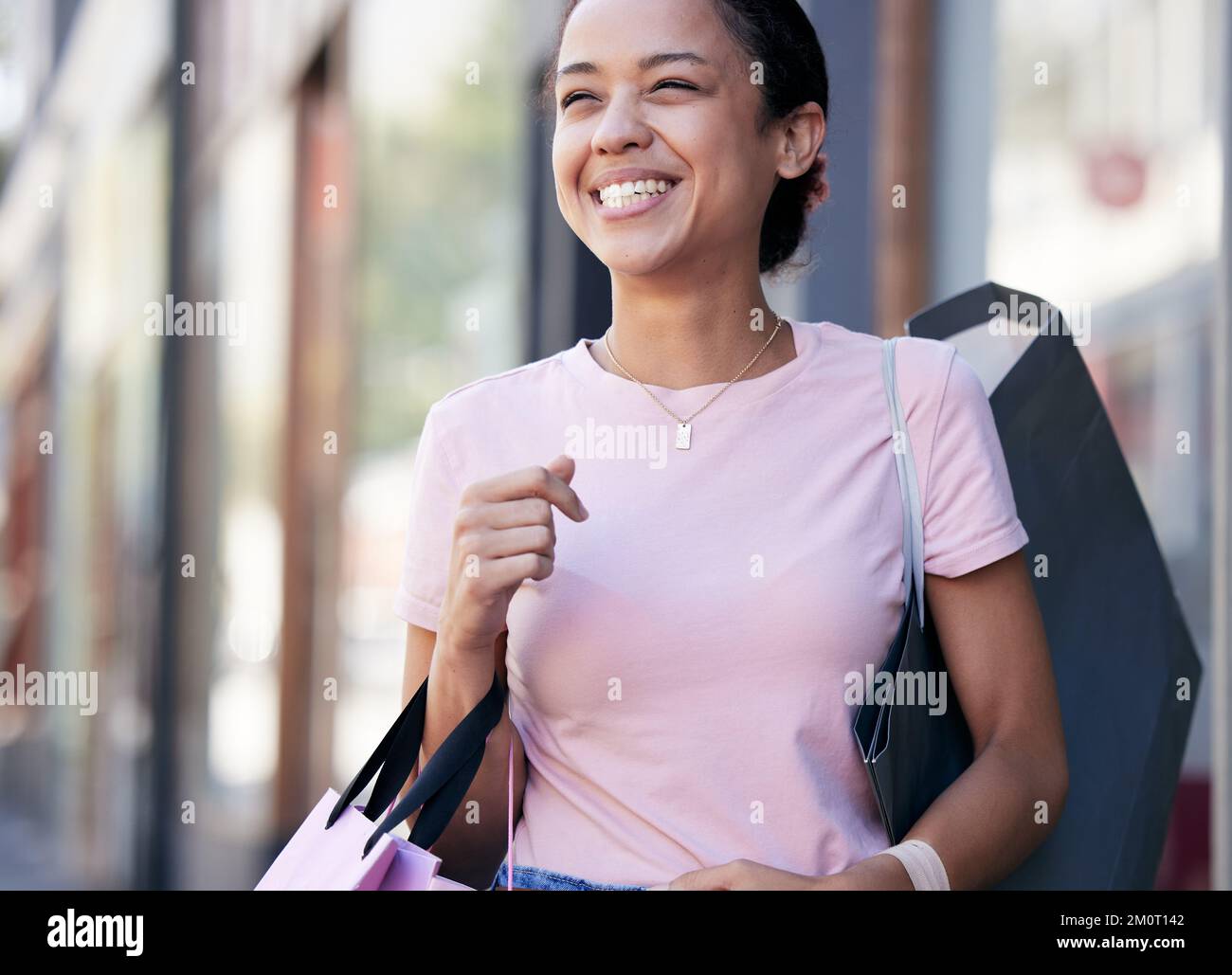 Happy, asian and woman in city with shopping bag and satisfied smile for retail products purchase. Sale, discount and promotion at shop in New York Stock Photo