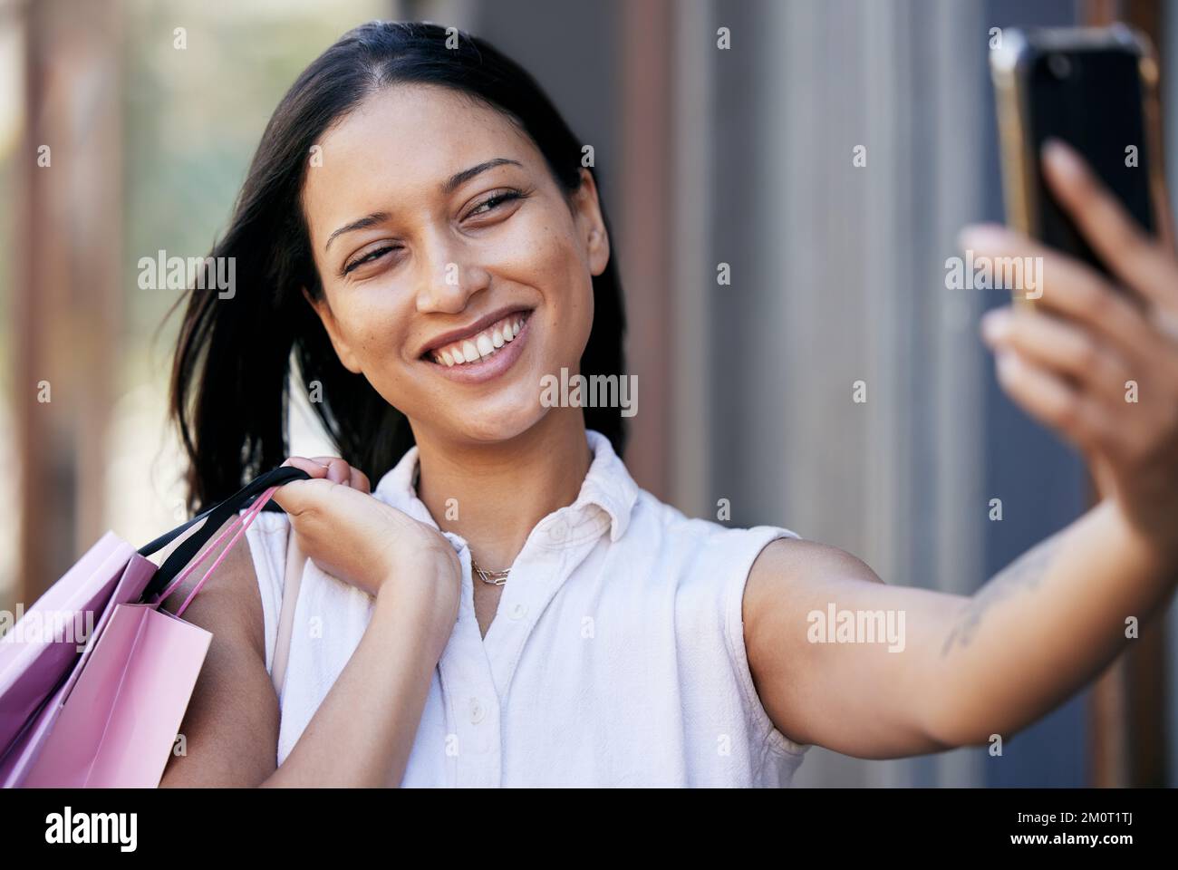 Woman, city shopping and phone selfie, social media post and fashion influencer with mobile app, technology and connection. Happy shopper girl Stock Photo