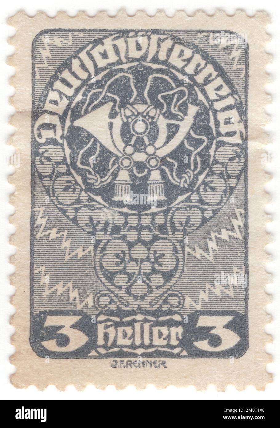 AUSTRIA - 1919: An 3 heller grey postage stamp depicting Post Horn, issue of the Republic. The post horn (also post-horn) is a valveless cylindrical brass instrument with a cupped mouthpiece. The instrument was used to signal the arrival or departure of a post rider or mail coach. It was used especially by postilions of the 18th and 19th centuries Stock Photo