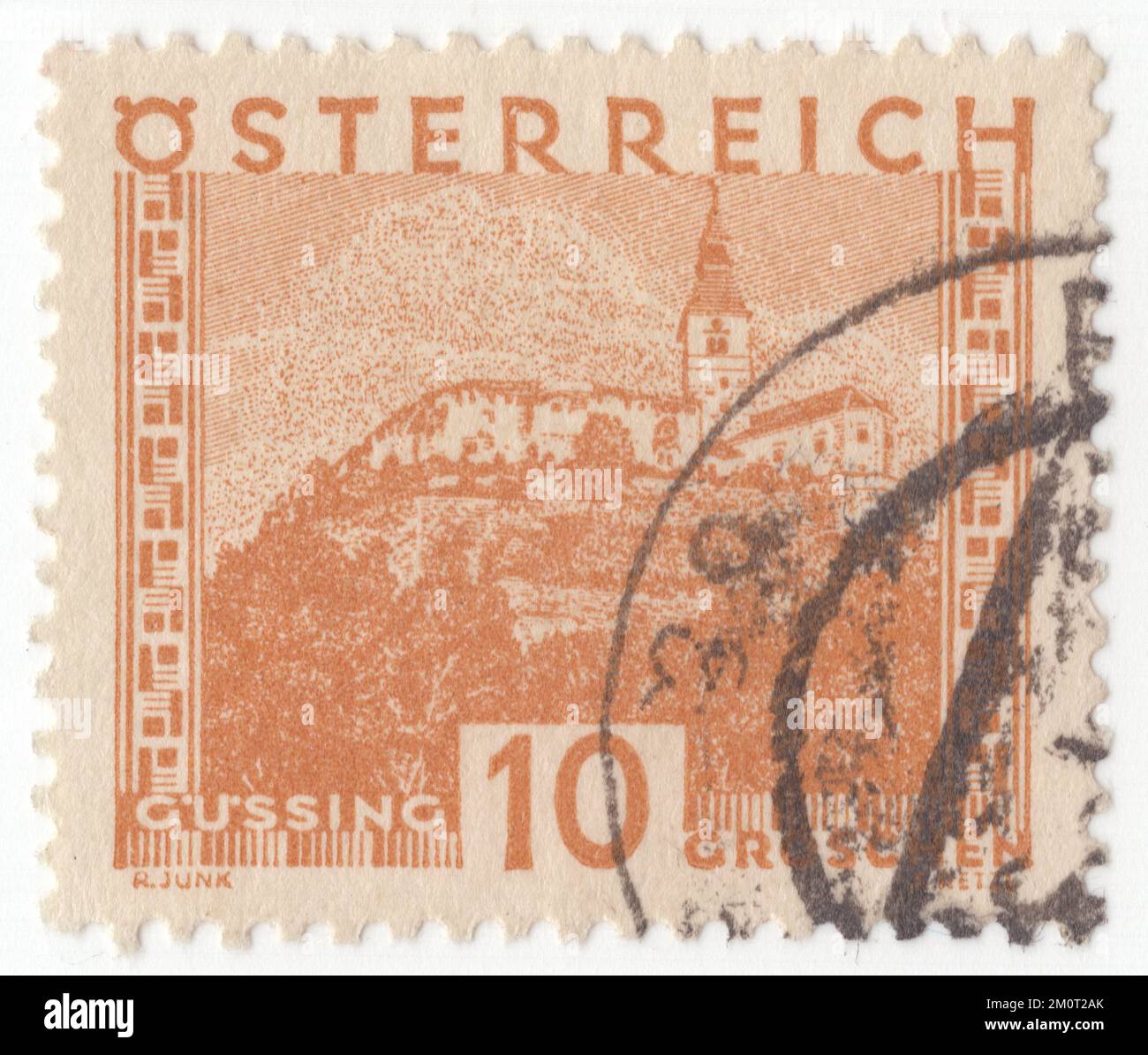 AUSTRIA - 1929: Original canceled Austrian 10 groschen postage stamp in brown orange. Austrian cities: Gussing Stock Photo
