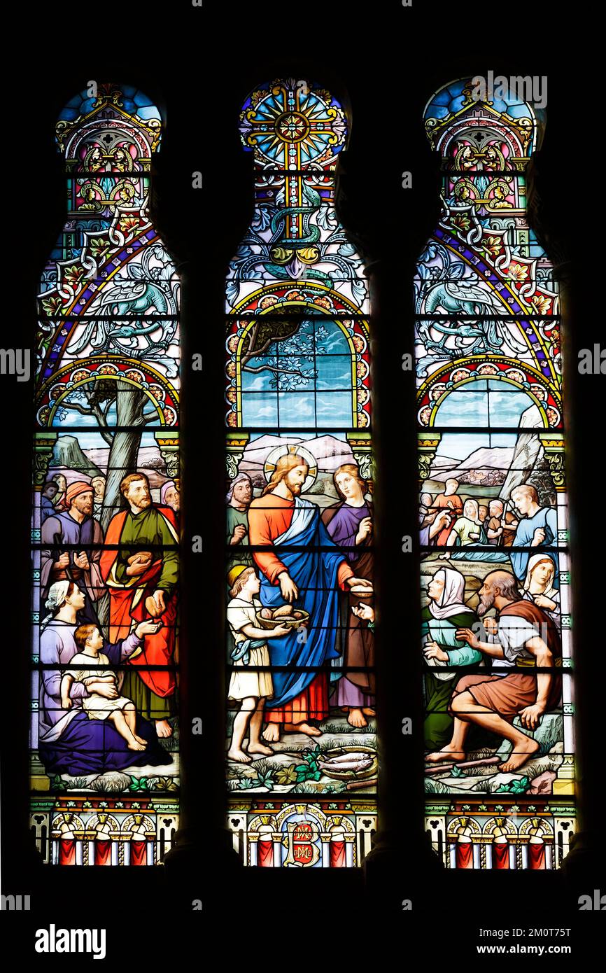 France, Meurthe et Moselle, Nancy, the Sacre Coeur de Nancy basilica in Roman Byzantin style located Rue de Laxou, stained glass window by Jules Janin called La multiplication des pains (the multiplication of bread) destroyed by shelling in 1917 restored in 1922 by Georges Janin and Jerome Benoit with addition of vegetal decoration reminding the skylights of Art Nouveau style Stock Photo
