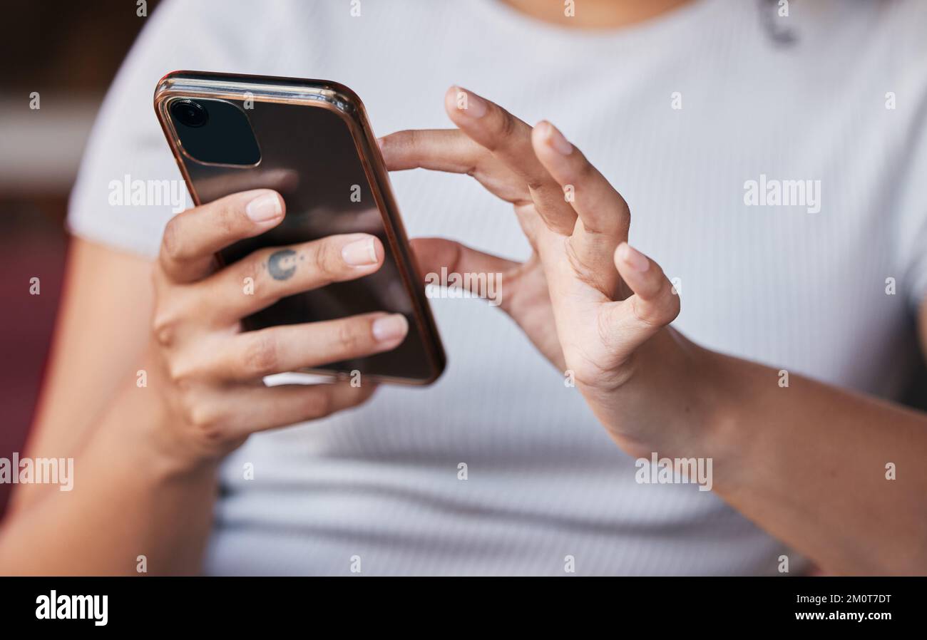 Hands, phone and woman on social media in home, texting or internet browsing. Zoom, cellphone and female with mobile smartphone for messaging Stock Photo
