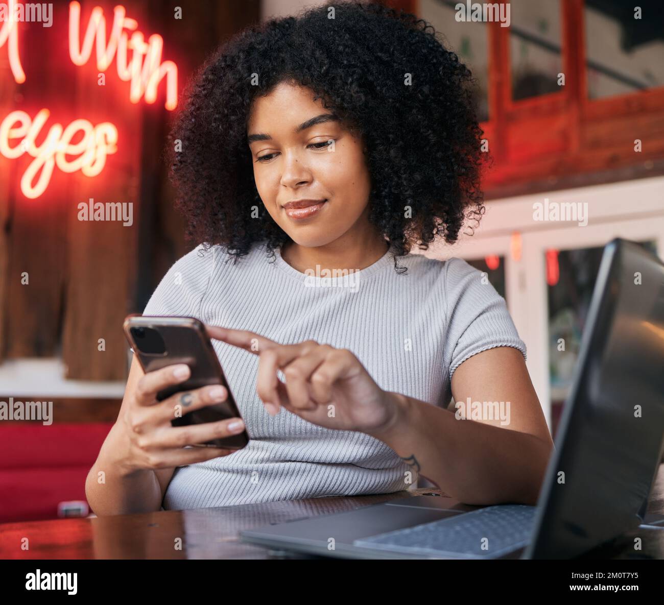 Freelance, woman and phone in a cafe while searching online with wifi for blogging and social media ideas. Remote, influencer and browse mobile social Stock Photo