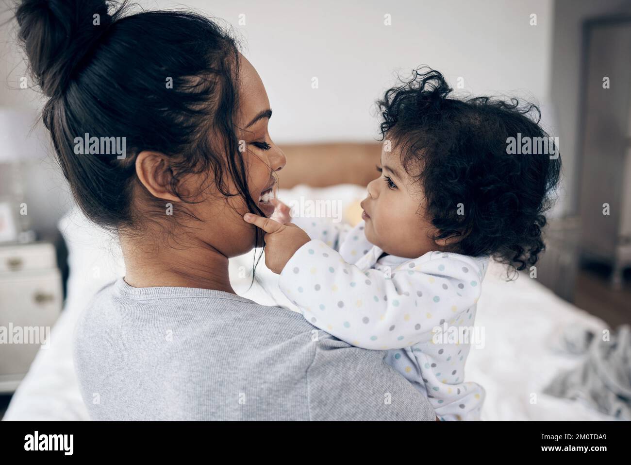 Unconditional. a mother holding her baby daughter at home. Stock Photo