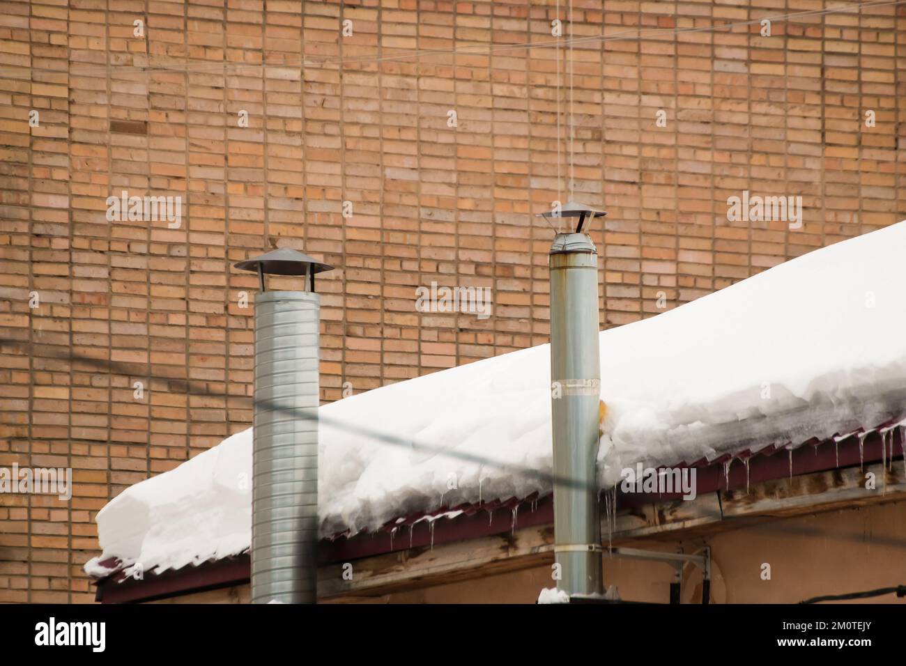 Metal exhaust ventilation pipes on the background of a brick wall. Roof