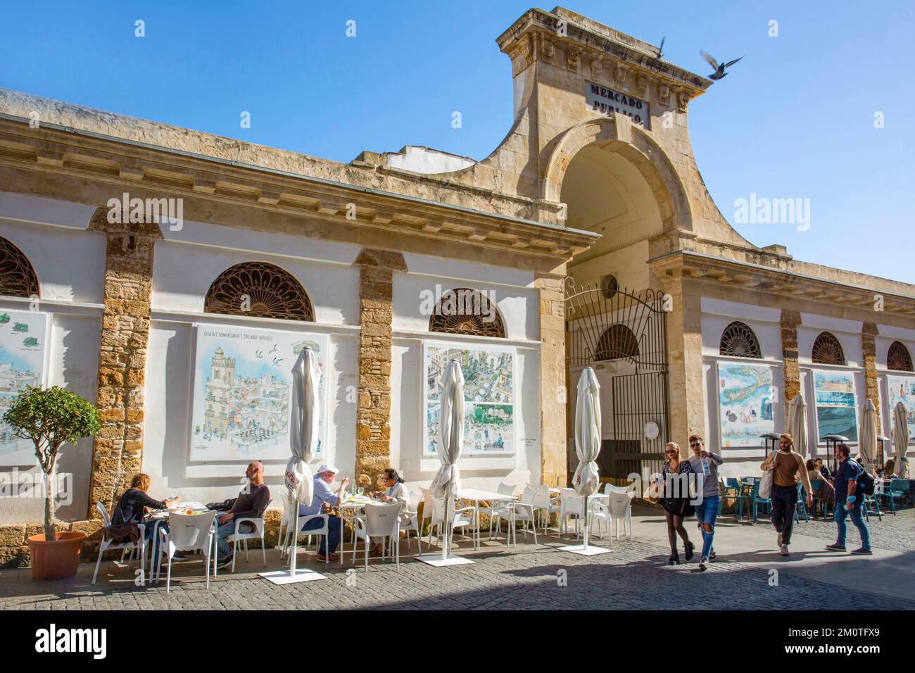 Spain, Andalusia, Cadiz, central market, restaurant terraces set up in front of the central market decorated with drawings of the city Stock Photo