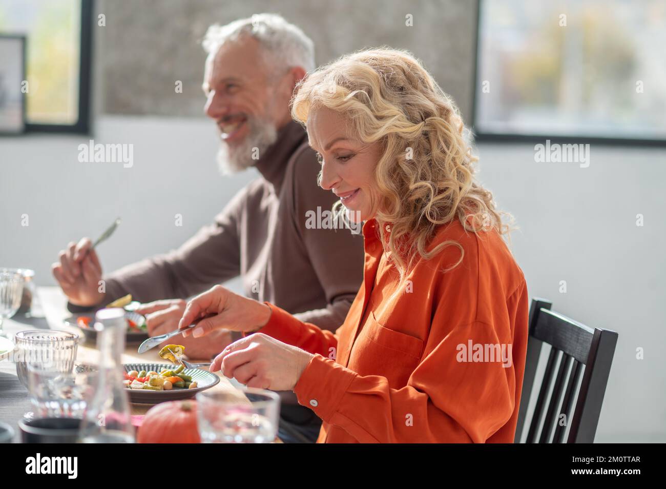 Mature couple sitting at the table and having dinner Stock Photo