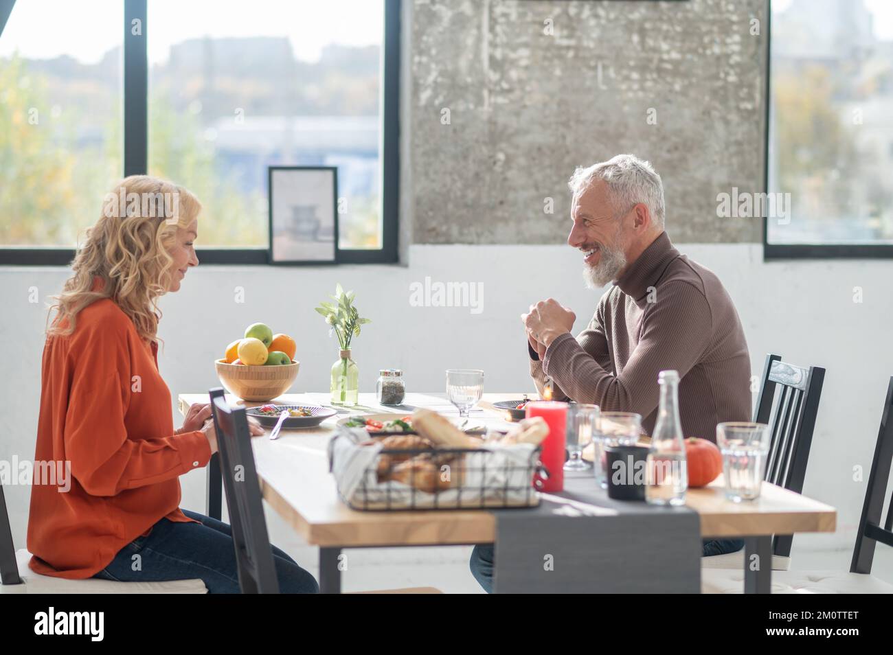 Mature couple sitting at the table and having dinner Stock Photo