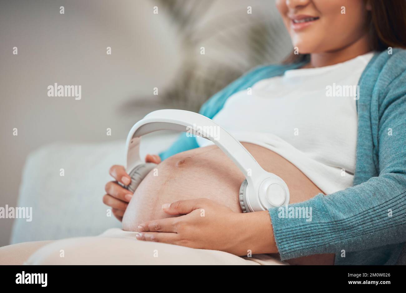 Melodies in the womb: Headphones placed on a pregnant belly, bonding  through music, a heartwarming connection between mother and baby Stock  Photo - Alamy