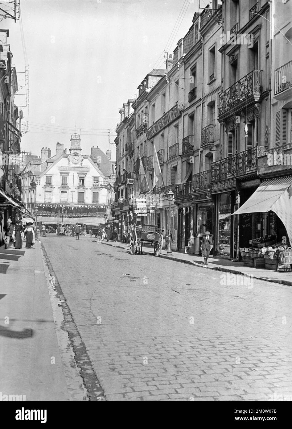 A vintage late 19th Century black and white photograph showing the centre of Dieppe in France. The Cafe Des Tribunaux at the end of the street. Stock Photo