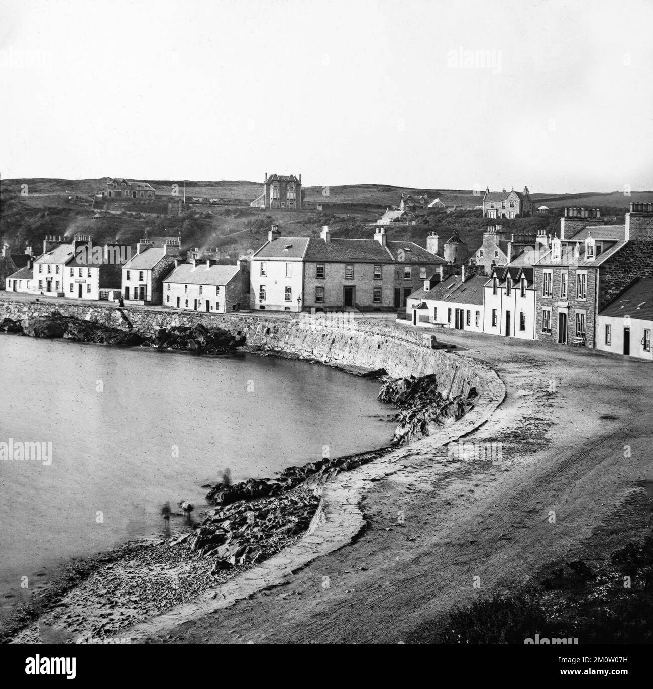 Early 20th century vintage black and white photograph looking down on Shore Street in Portpatrick in Dumfries and Galloway in Scotland. Stock Photo