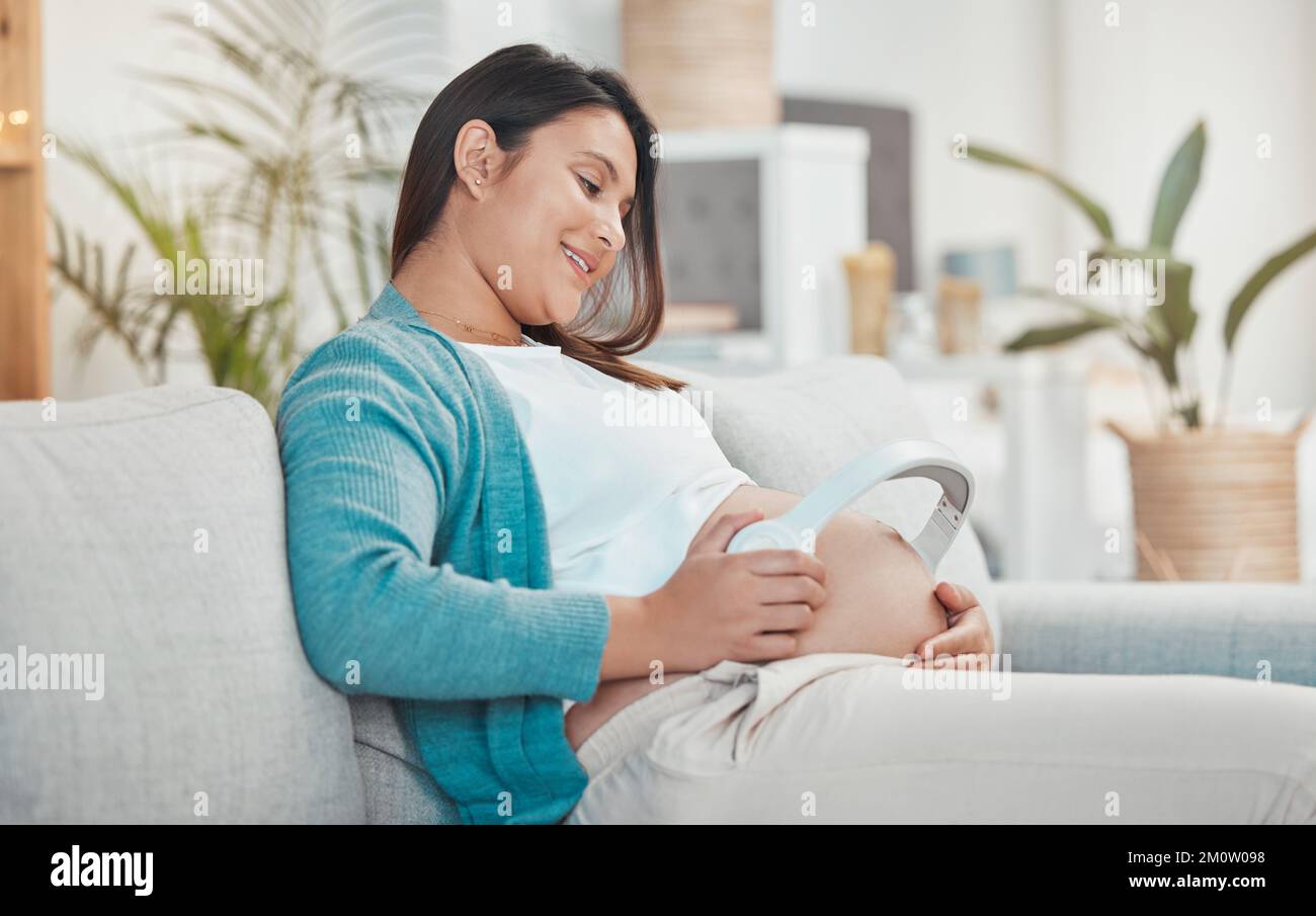 Pregnant, woman and stomach with headphones for music for her unborn