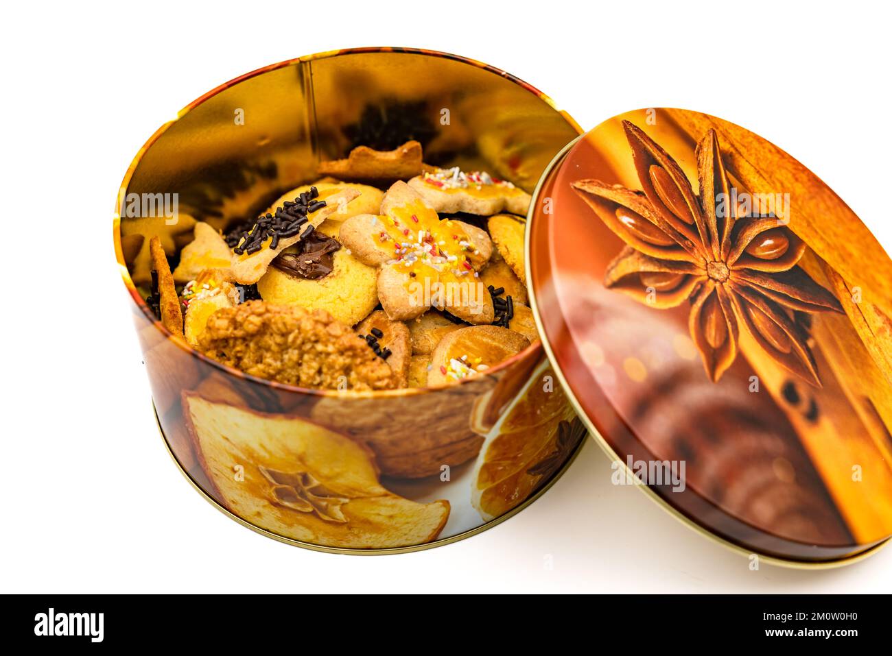 A colorfully painted tin with golden baked biscuits, small baked goods and cookies for the Advent season Stock Photo
