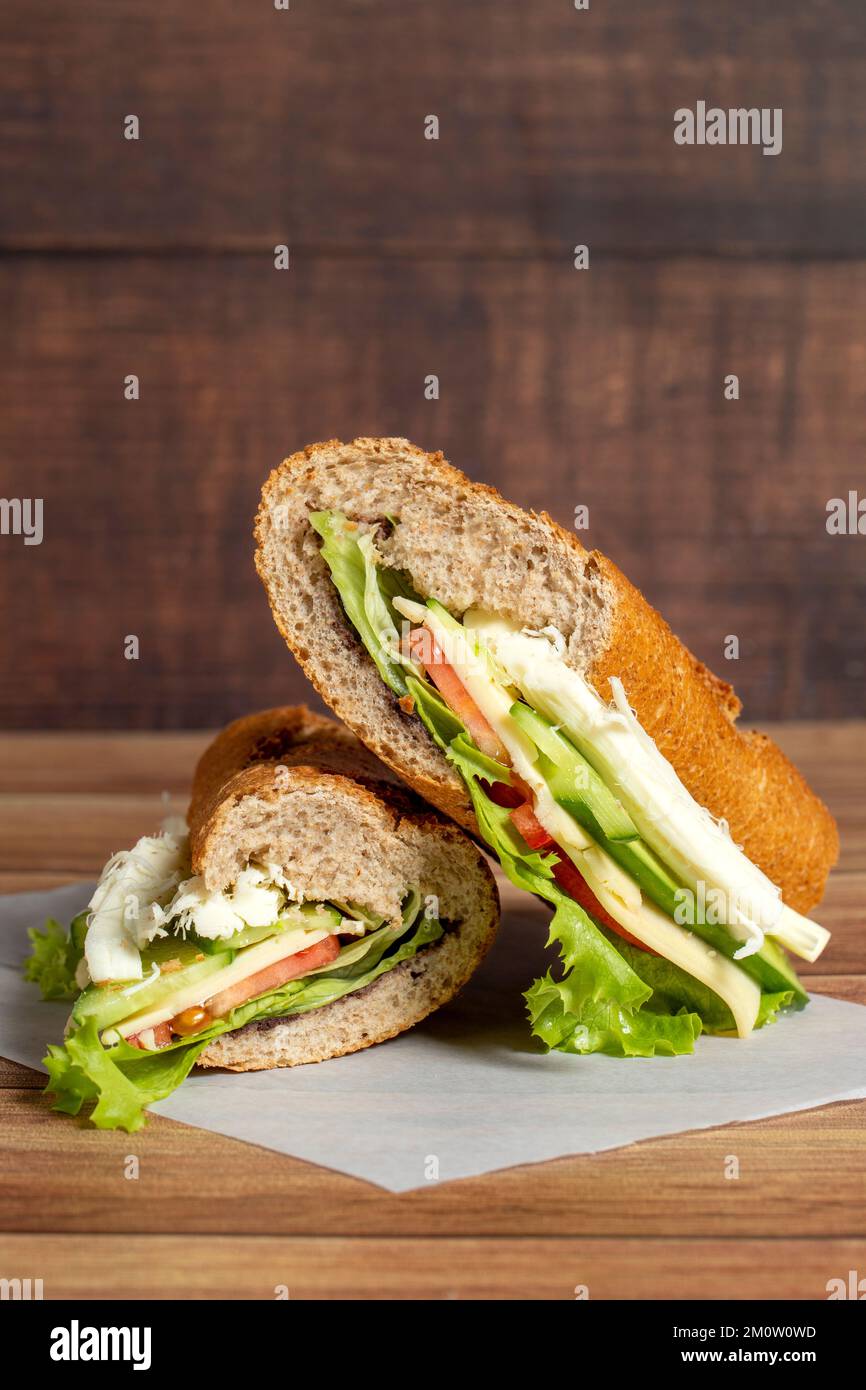 Baguette sandwich. Sandwich with olives, lettuce, tomato, cucumber