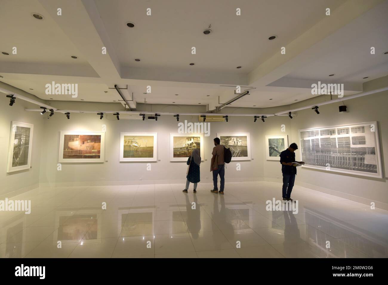 Dhaka. 8th Dec, 2022. Visitors view an art exhibition showcasing