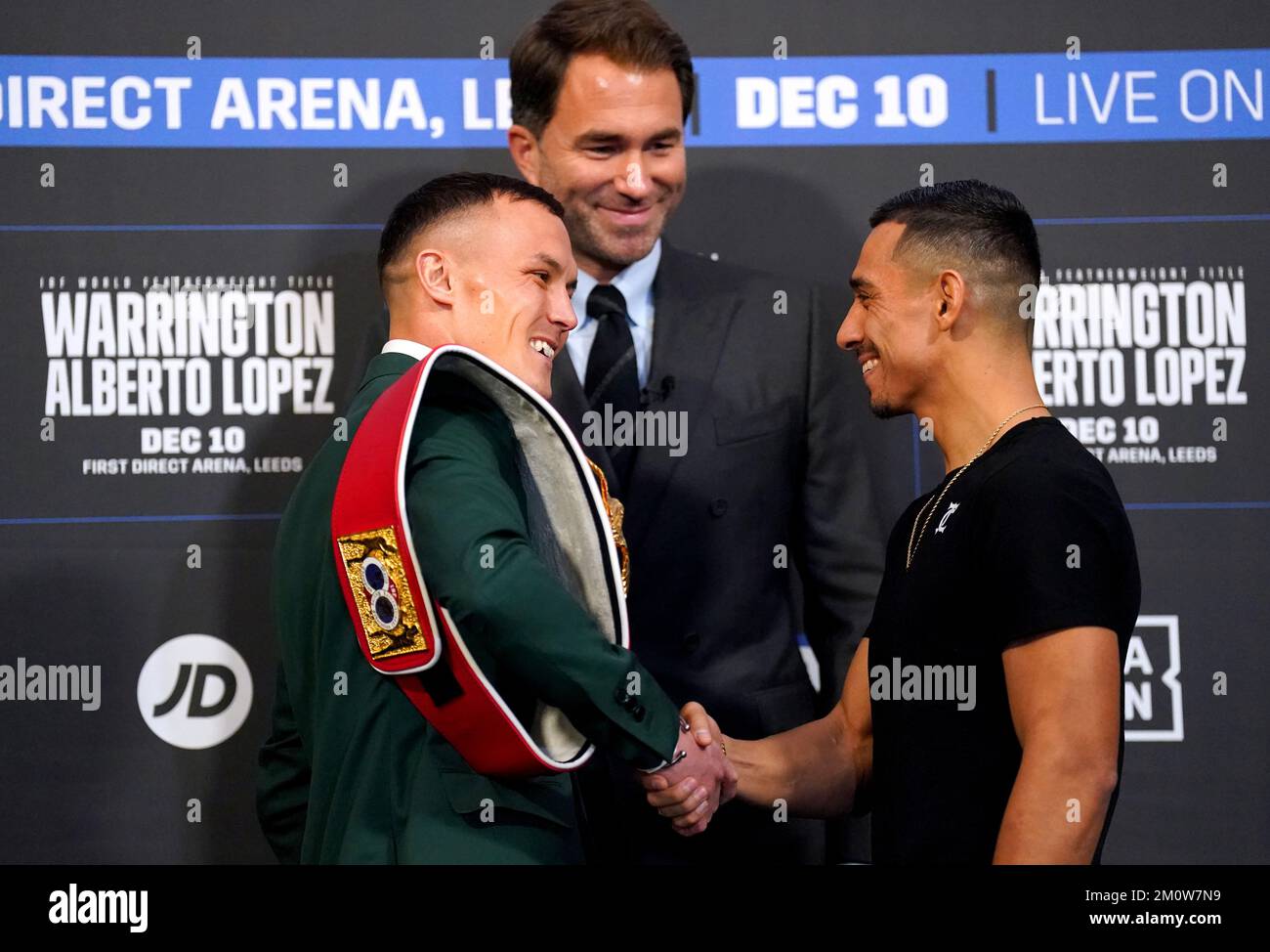 Boxing promoter Eddie Hearn looks on as Josh Warrington (left) shakes hands with Luis Alberto Lopez as they face off during a press conference at Aspire, Leeds. Picture date: Thursday December 8, 2022. Stock Photo