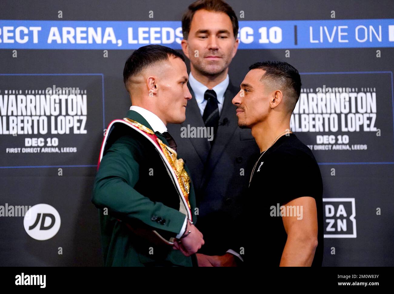Boxing promoter Eddie Hearn looks on as Josh Warrington (left) and Luis Alberto Lopez face off during a press conference at Aspire, Leeds. Picture date: Thursday December 8, 2022. Stock Photo