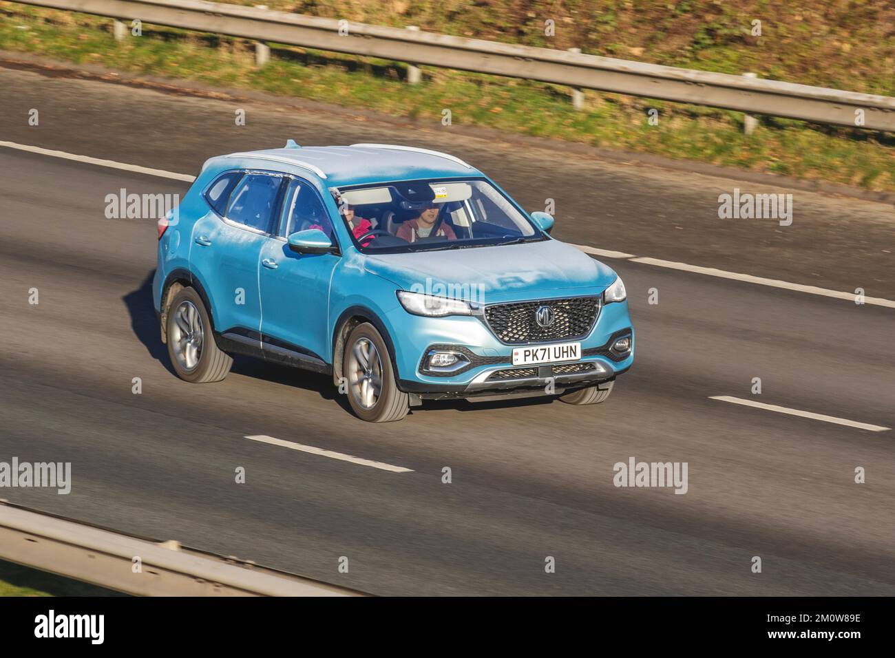Ice on moving car   2021 Blue MG HS EXCITE PHEV AUTO petrol-electric 10-speed automatic. Frosted cars on a cold winter morning. Wintertime low temperatures with December frost and cold driving conditions on the M61 motorway, UK Stock Photo