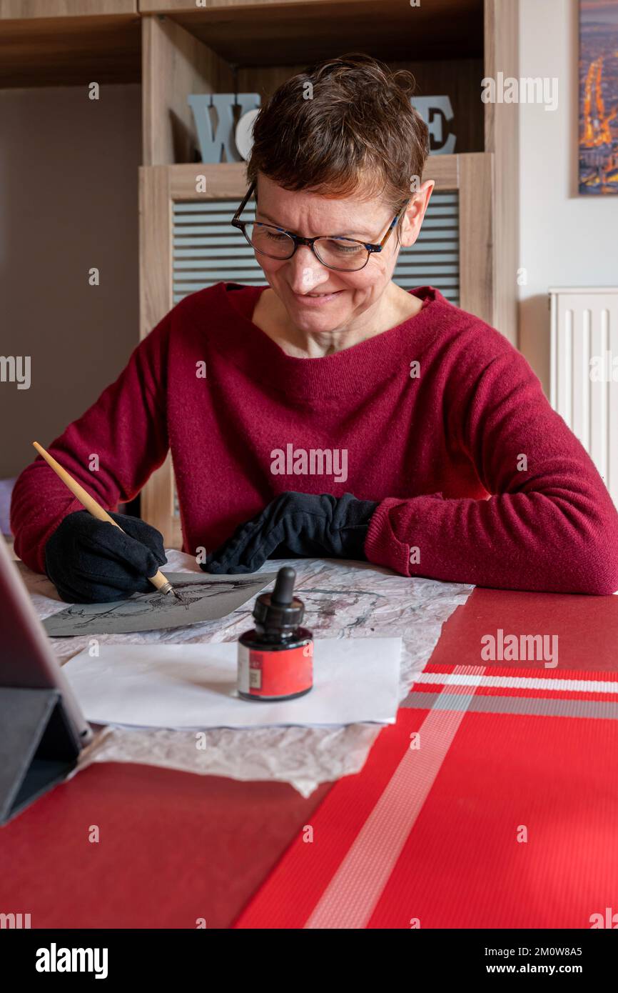 Woman Apple Ink Woman draws in ink with a feather Stock Photo - Alamy