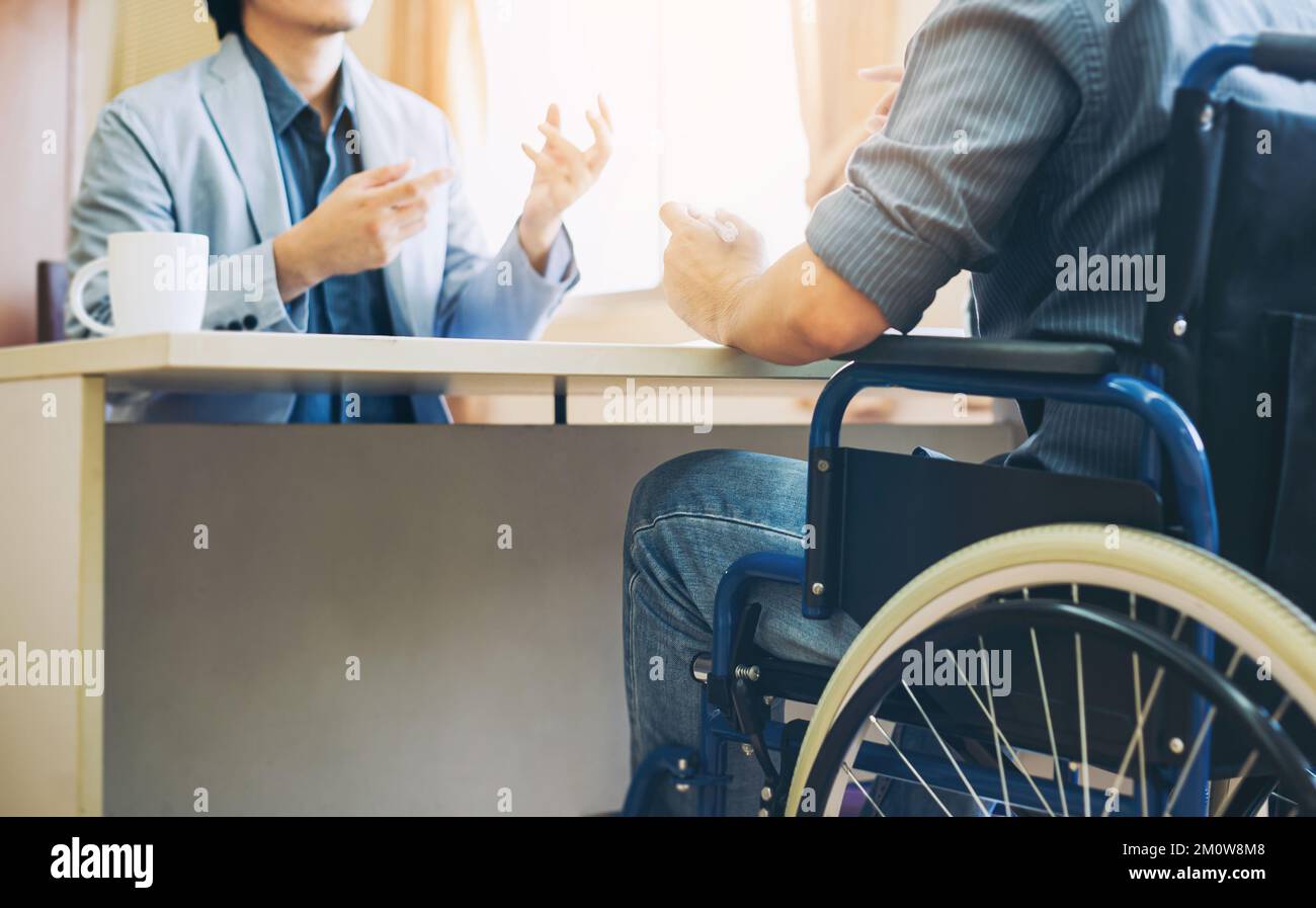 After accident and rehabilitation, disabled man can return to work again. Job hiring employing disable people concept. Stock Photo