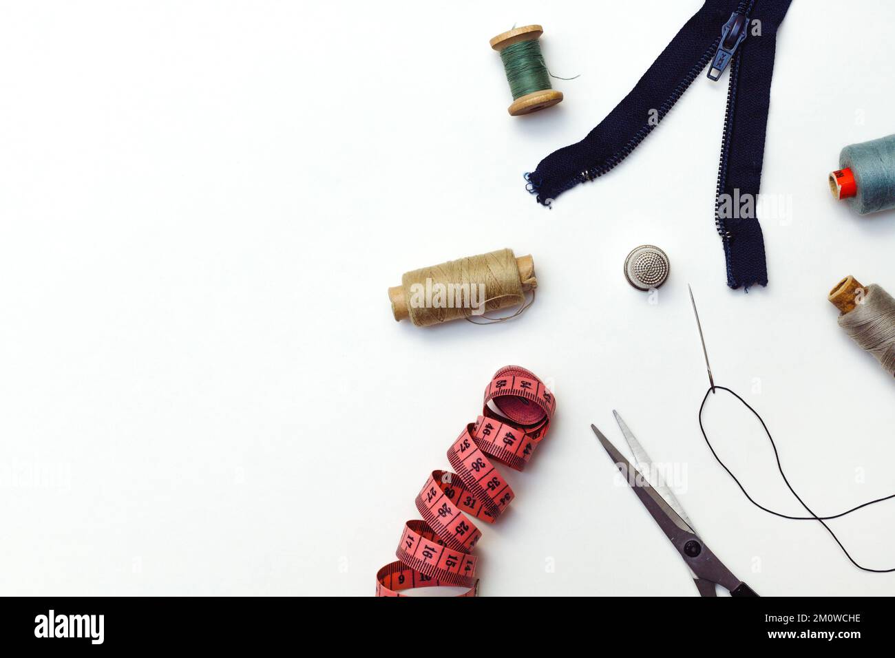 Sewing accessories for repairing clothes, layout on a white background, top view Stock Photo
