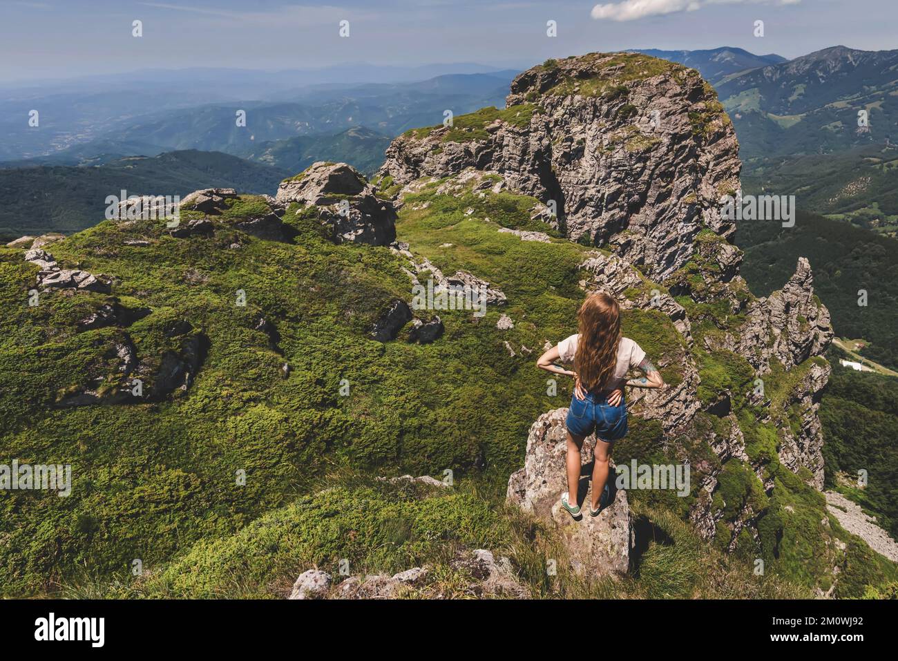 Woman Hiker Standing Alone on Rock of Mountain Stock Photo